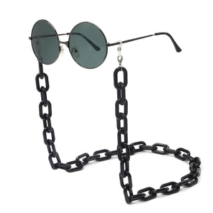 Detail of chunky black acrylic eyeglass chain with vintage round sunglasses