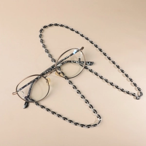 Detail of acrylic eyeglass chain with marble texture and adjustable silicone loops