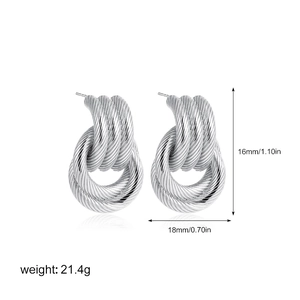 Detail view of 18K silver intertwined knotted earrings with 16mm height and size markings
