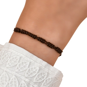 Close-up of hand-woven dark brown leather cord bracelet with vintage knot design