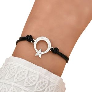Detail of star and moon leather cord bracelet with sparkling crystal inlay on wrist
