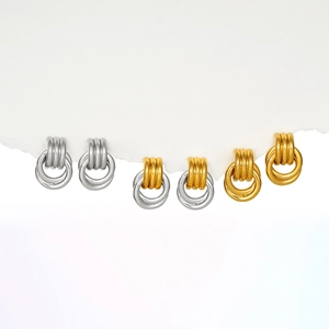 Detailed view of three pairs of geometric double hoop earrings in gold and silver finishes