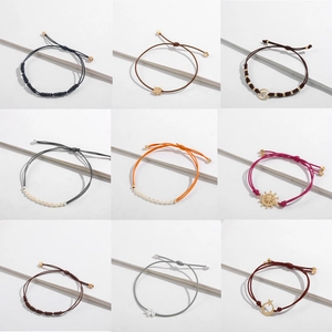 Minimalist leather cord bracelets with nautical charms including anchor and pearls