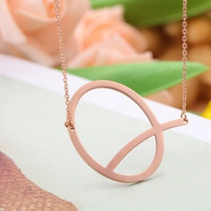 Rose gold stainless steel necklace with geometric circular pendant on floral background