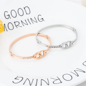 Polished rose gold and silver handcuff-style stainless steel bracelets with crystals