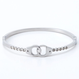 Silver stainless steel handcuff bangle with sparkling cubic zirconia on white background