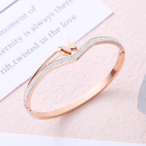 Rose gold butterfly titanium steel bangle featuring pavé crystals and matte finish texture