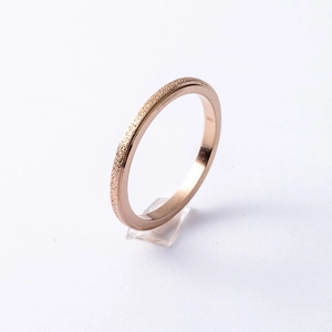 Macro view of 2mm rose gold frosted stainless steel ring with polished inner surface