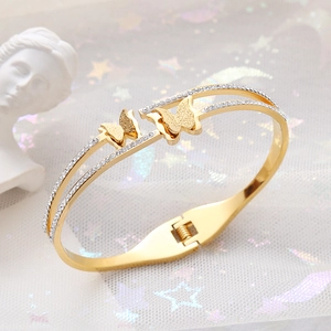 Golden double-layer butterfly cuff bracelet with rhinestones and frosted finish
