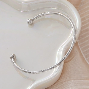 Minimalist silver stainless steel C-shaped cuff bracelet with spiral texture and ball ends