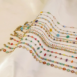 Colorful stainless steel daisy necklaces with evil eye and heart charms on silk cloth