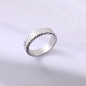Minimalist rotating stainless steel Heart Sutra ring with a matte finish on mesh background