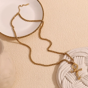 Detail of 18K gold snake pendant with Ankh Cross and zircons on thick wheat chain