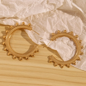 Detail of 18K gold plated hoop earrings featuring intricate wheat grain texture and beads