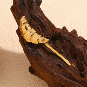 Detailed macro view of an 18K gold-plated stainless steel croissant shaped hair clip