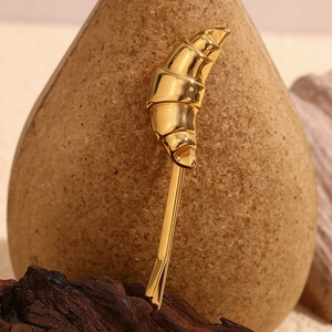 Macro shot of 18K gold plated stainless steel croissant hair clip with glossy finish