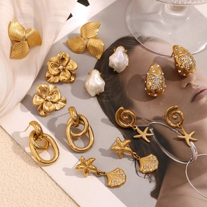 Detail of 18K gold plated earrings featuring pearls, starfish motifs and crystal accents