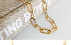 Détail macro du collier chaîne trombone plaqué or 18 carats poli pour femmes
