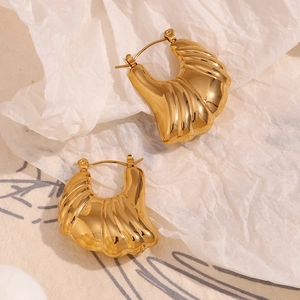 Detail of 18K gold plated croissant dome hoop earrings with mirror polished finish