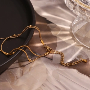 Detail of 18K gold-plated double-layer snake chain anklet with lobster clasp and extension