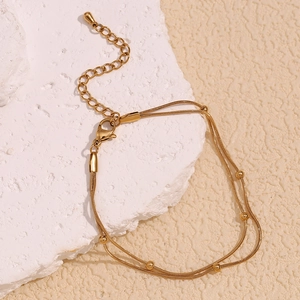 Detail of 18K gold-plated stainless steel double-layered snake chain with beads