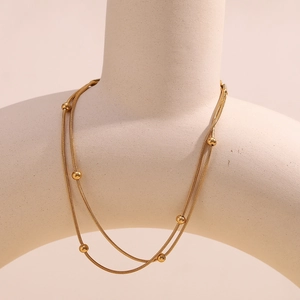Double-layered 18K gold plated snake chain anklet with round beads on a display