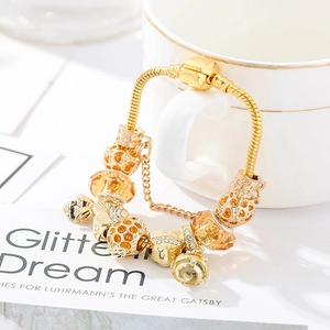 Golden bee-themed snake chain bracelet with honeycomb beads and orange crystal charms