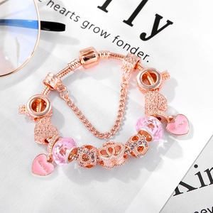 Rose gold heart charm bracelet with pink crystals and Mother pendant on white background