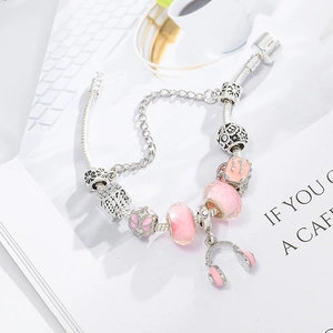 Pink charm bracelet with headphone pendant and pink glass beads on silver snake chain
