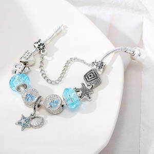 Ocean-themed silver charm bracelet with light blue crystal beads and starfish pendant