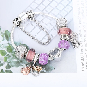 Silver snake chain bracelet with purple glass beads and heart clover charms