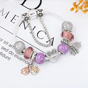 Silver snake chain bracelet with purple glass beads and lucky charm clover pendants