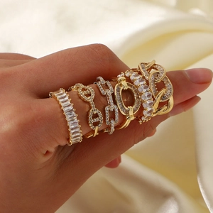 Elegant gold-plated stackable ring set with cubic zirconia on cream silk background