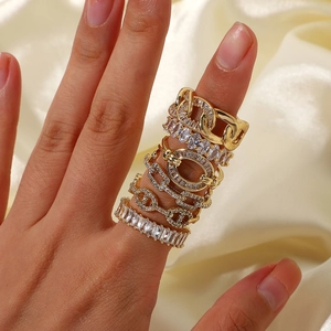 Detailed view of 5-piece gold stackable ring set with cubic zirconia on satin