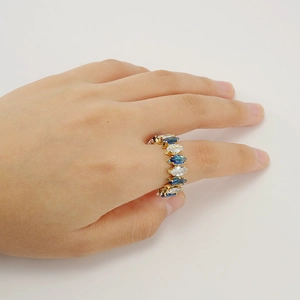 Detail of adjustable 18K gold plated ring with marquise-cut blue and white crystals
