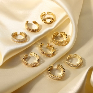 Set of 8 minimalist 18K gold plated rings with zircon insets on silk fabric
