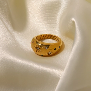 Vintage gold chunky star ring with multi-color zircons on elegant beige silk background