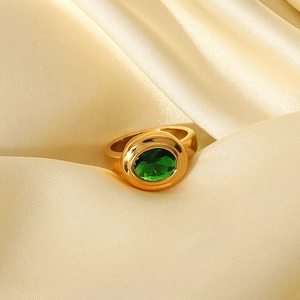 Retro 18K gold plated stainless steel ring with an oval green zircon on champagne silk