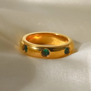 Macro shot of 18K gold plated stainless steel ring with inlaid green zircon stones