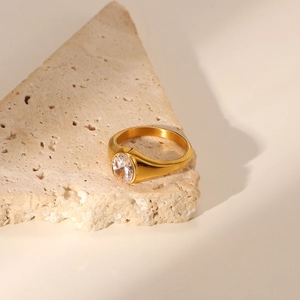 Macro view of a 18K gold-plated stainless steel ring with an inlaid green zircon stone