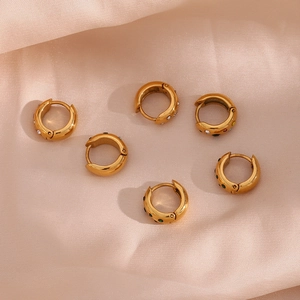 Detailed view of chunky gold-plated stainless steel hoop earrings with colorful zircon stones