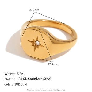 Detail of 18K gold plated signet ring with starburst engraving and centered crystal