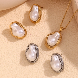 Detailed view of baroque pearl earrings and necklace with twisted 18K gold-plated borders