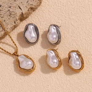 Detailed view of baroque pearl jewelry set with irregular texture on a textured surface