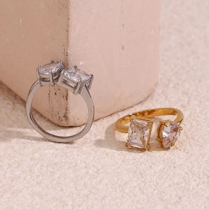 Detailed view of 18K gold and silver rings with pear and emerald cut cubic zirconia