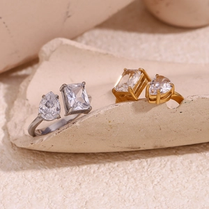 Macro detail of gold and silver open rings with pear and emerald cut zirconia stones