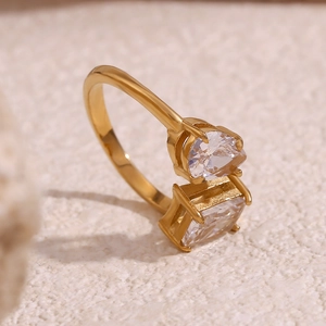 Close-up of 18K gold-plated open ring with pear and square-cut cubic zirconia crystals