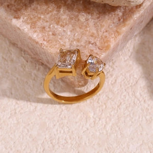 Close-up of 18K gold-plated open ring with emerald-cut and heart-shaped zircon stones