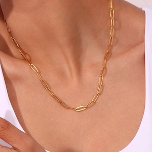 Detail van een 18K vergulde paperclip ketting gedragen door een model voor een chique look