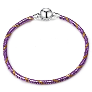 Purple snake bone bracelet with golden accents and silver spherical clasp on white background